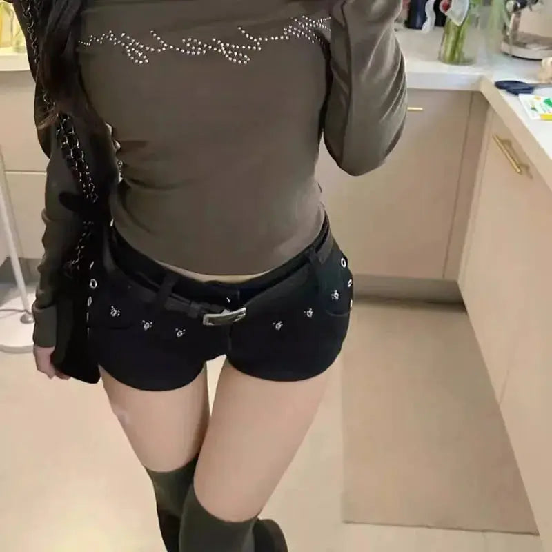 Black low-waist denim shorts with silver studs, Y2K punk-goth style