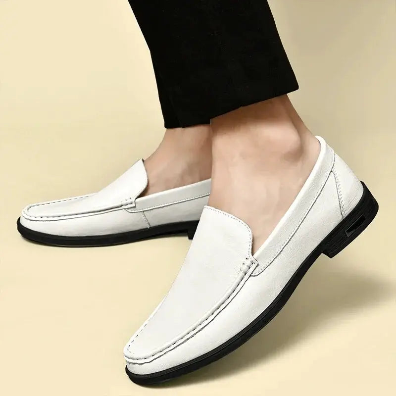 Leather men's slip-on loafers by Simples Market in white with black sole.
