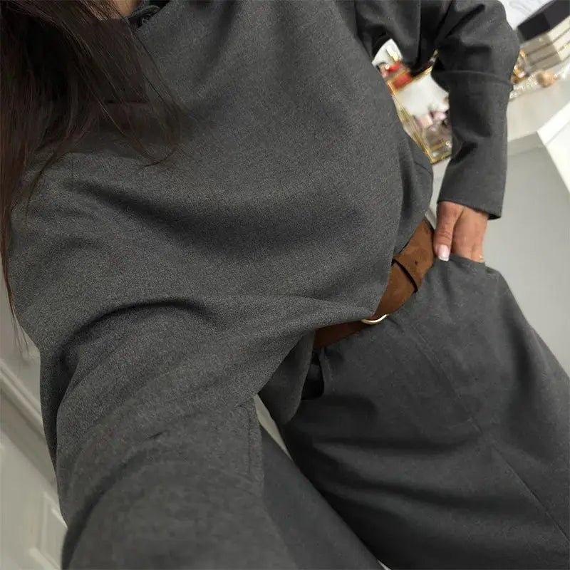 Grey women's blazer skirt suit with brown belt, polished commuter outfit.