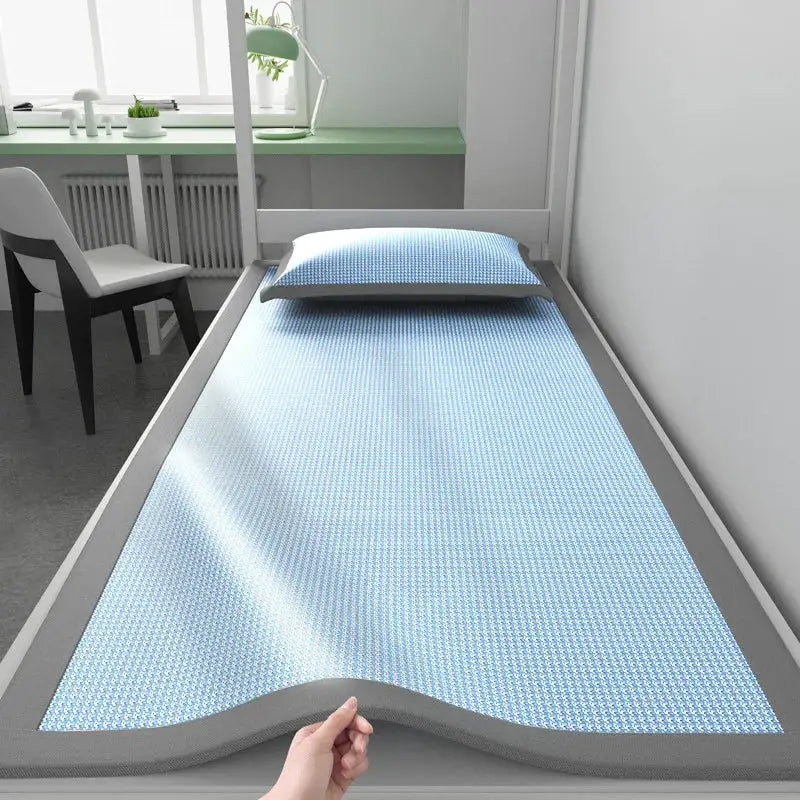 1-piece ice silk sleeping mat with blue jacquard cooling surface on a dorm bed, includes a pillow