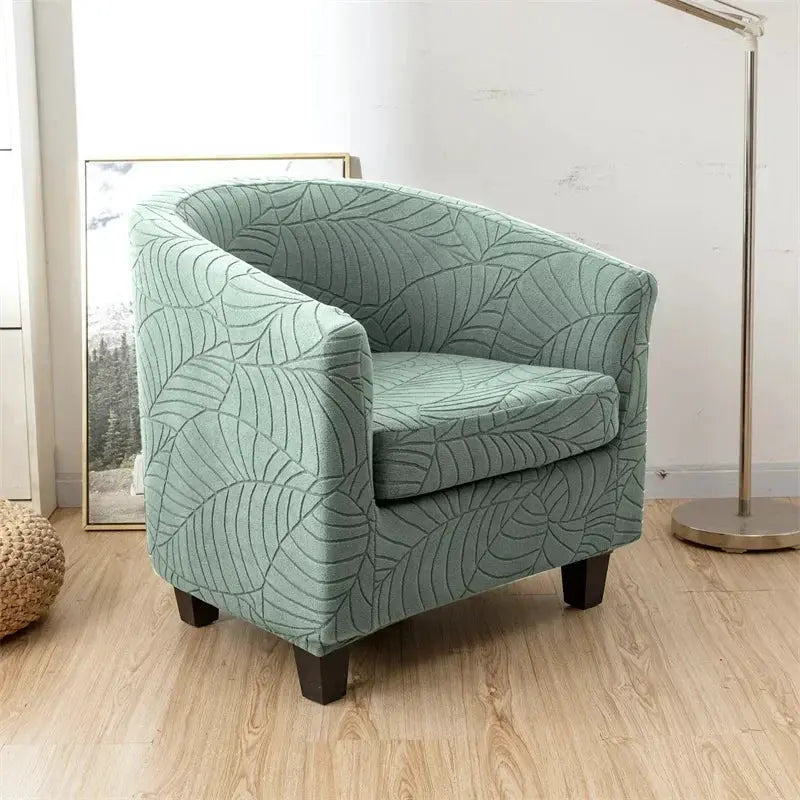 Leaves Jacquard tub chair cover in teal leaf pattern; Simples Market stretch slipcover for a single chair.