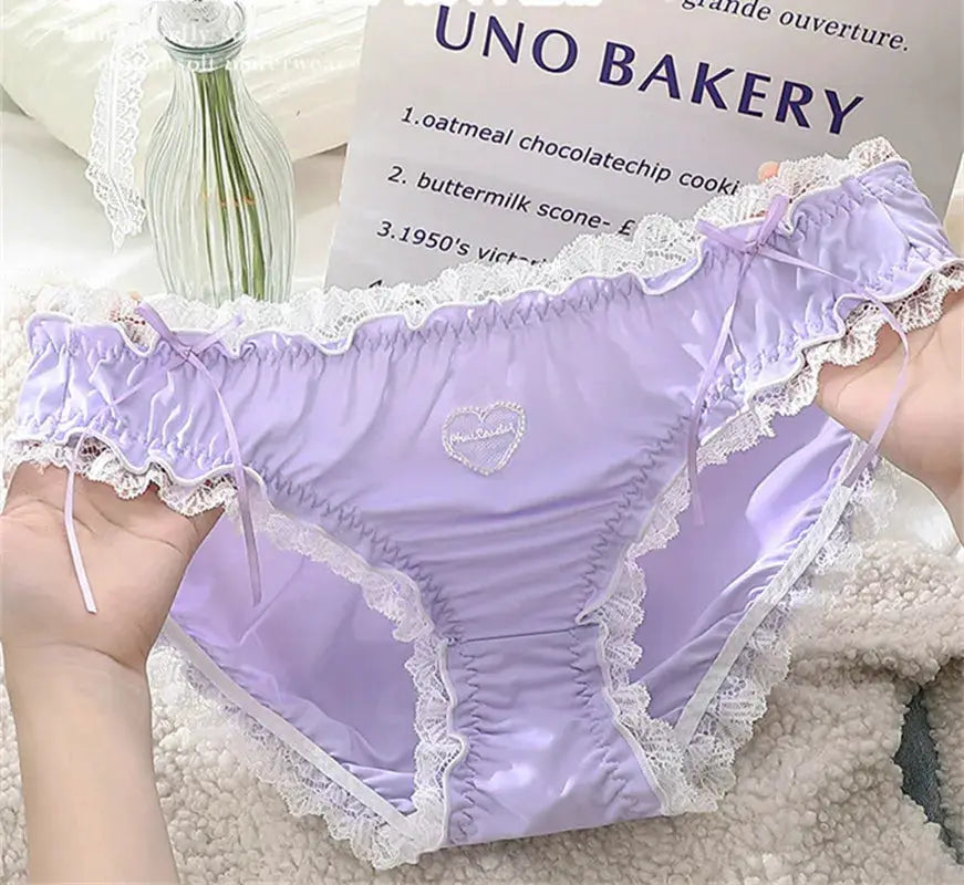 Plus-size lavender lace panties with white scalloped trim, side bows and a ruched front panel