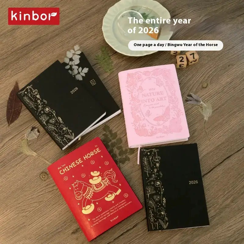 Five Kinbor planners and notebooks in black, red, and pink with 2026 covers.