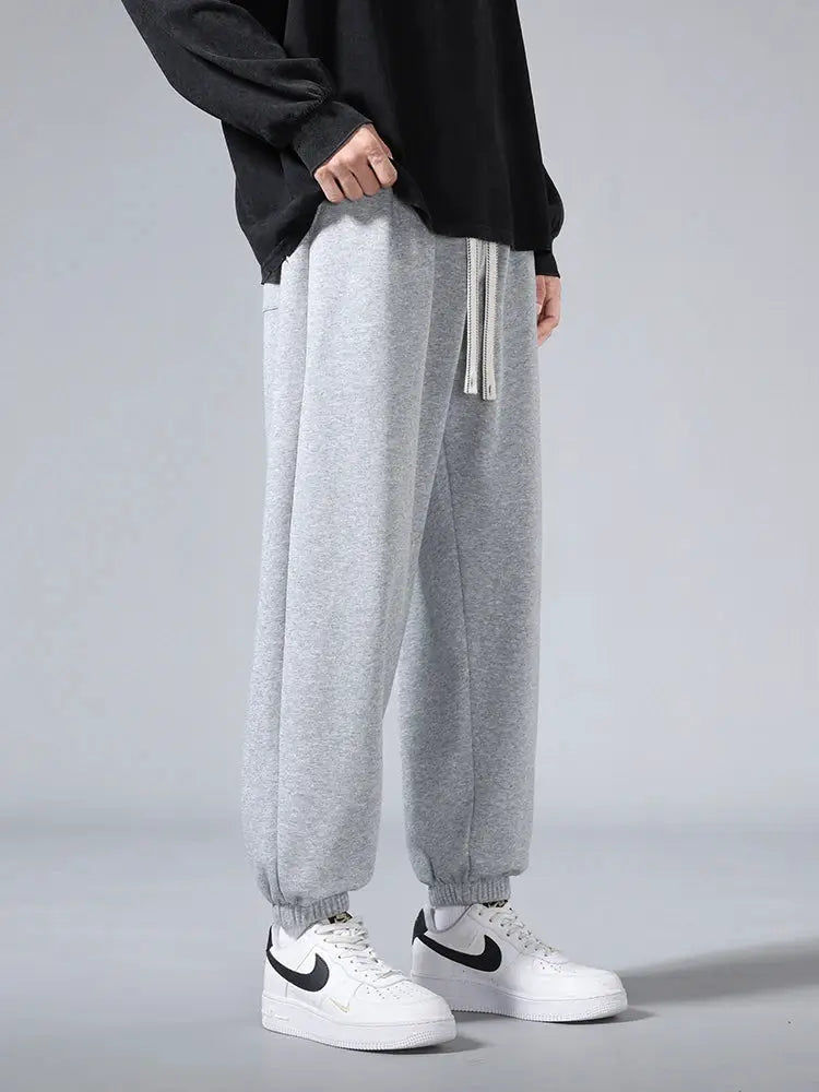 Men's jogger sweatpants by Simples Market in light grey cotton/polyester, baggy hip-hop style with drawstring.