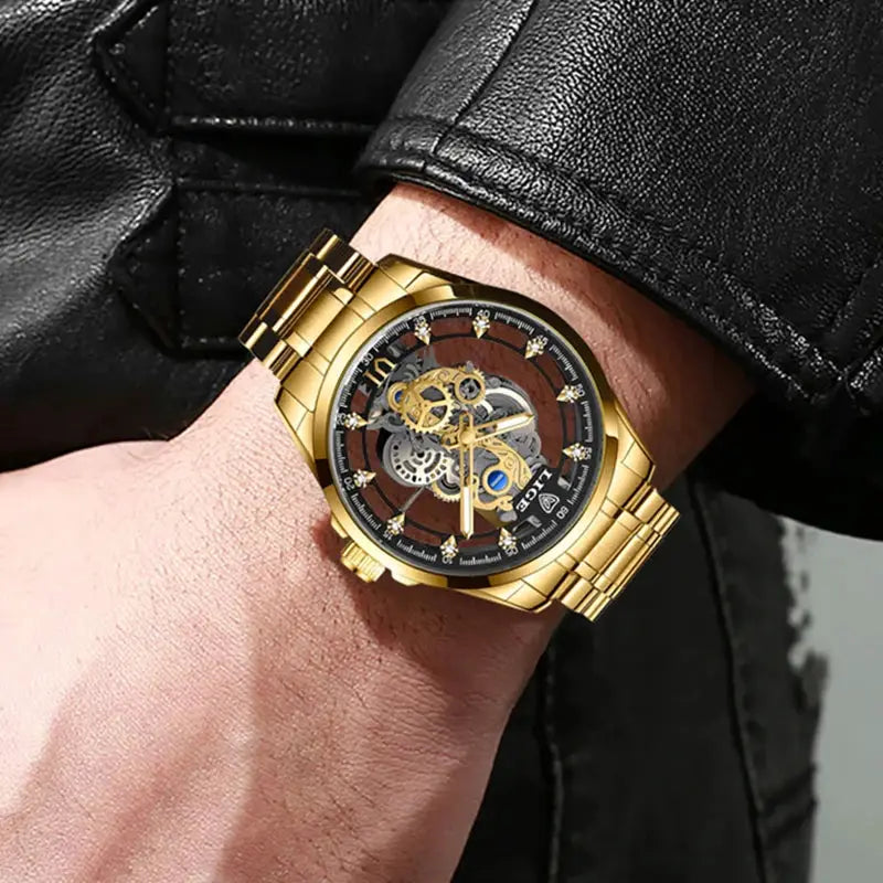 Gold stainless steel skeleton men's watch on wrist with visible gears and black dial