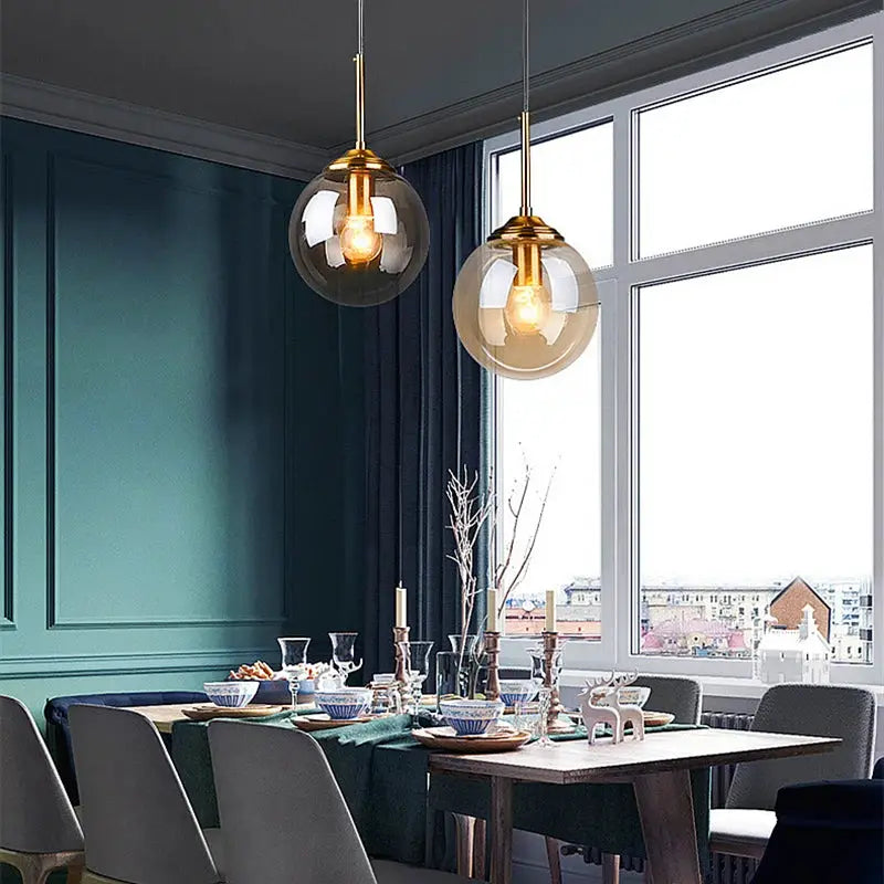 Modern luxury metal chandelier glass pendant lamps, gold-tone fittings with clear glass globes, two hanging lights