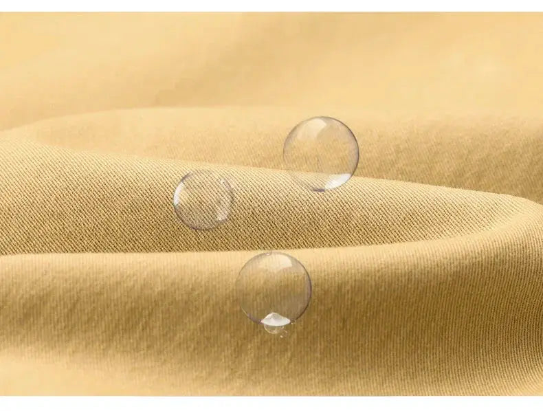 Khaki cotton fabric close-up with water droplets, showing the texture of casual men's pants material