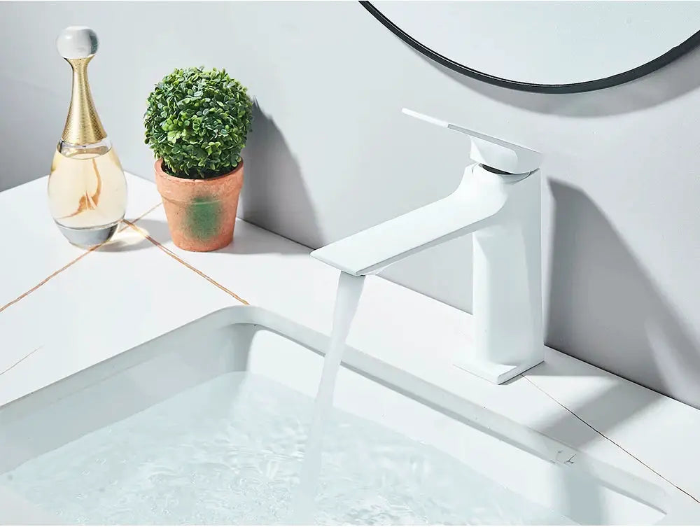 Deck-mounted bathroom sink mixer tap with single lever, white finish.