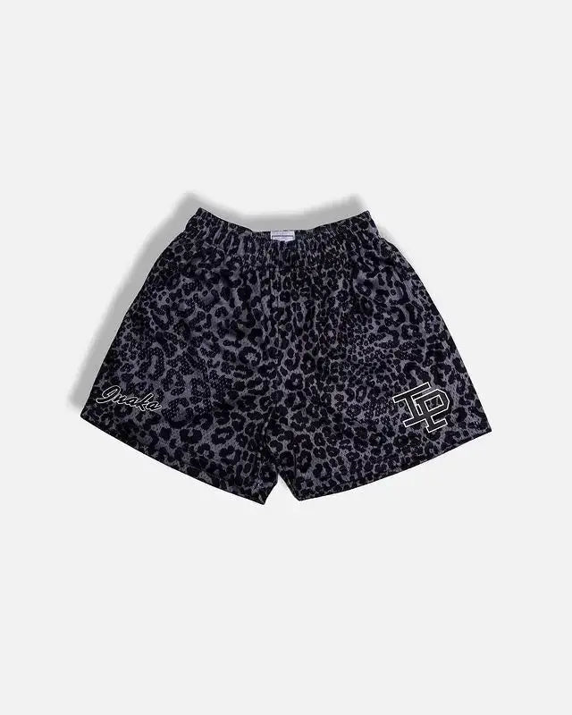Men's leopard-print athletic shorts with right-leg logo and left-script detail.
