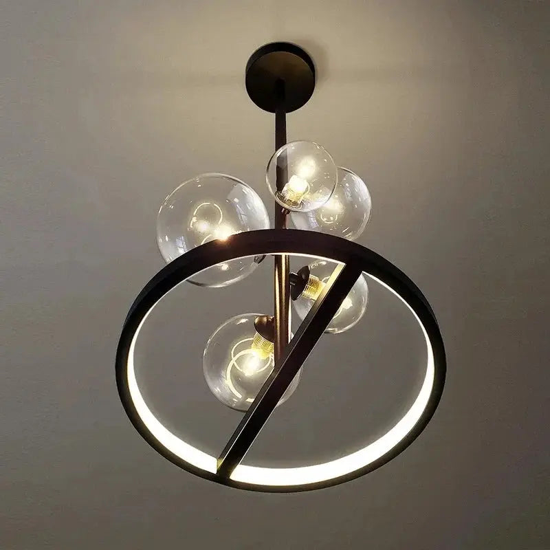 Modern art glass chandelier with a black circular ring and five clear glass globes, LED ring illumination.