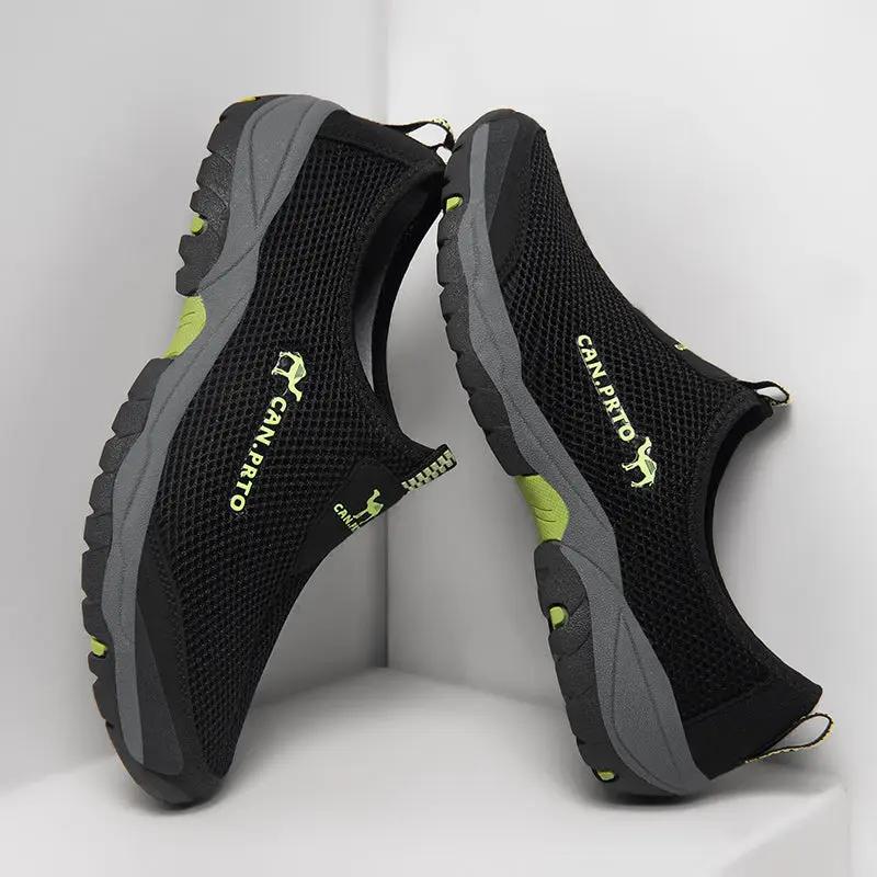 Pair of men's breathable mesh slip-on sneakers in black with gray soles and lime accents