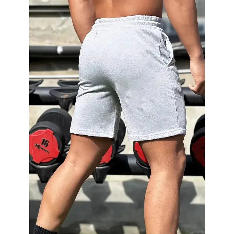 Men's light gray cotton shorts with elastic waistband and drawstring, casual fitness wear.