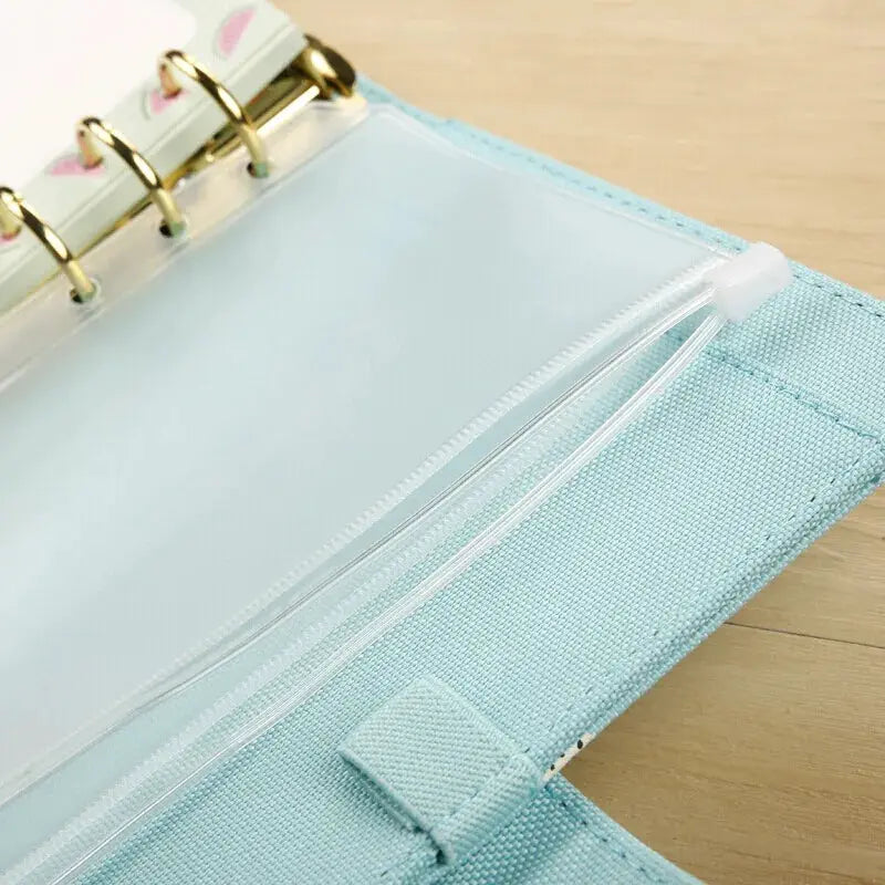 Zipper binder pouch in light blue with clear PVC pocket, attached to a 6-ring binder