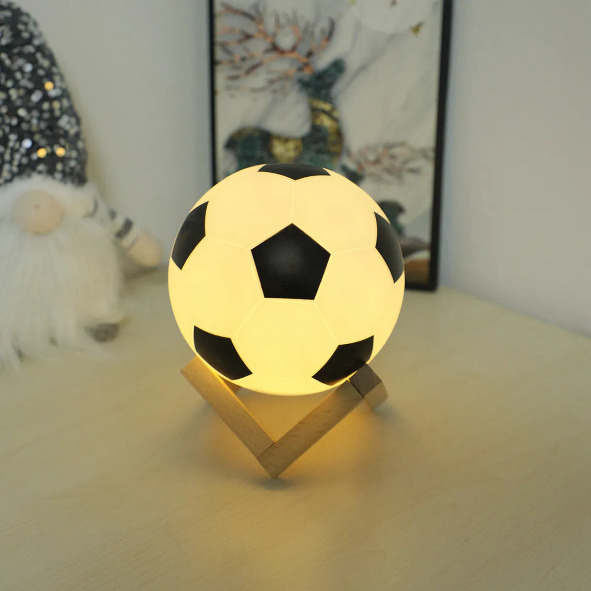 Football night light, 3D soccer-ball globe on a wooden stand with warm yellow glow, Simples Market