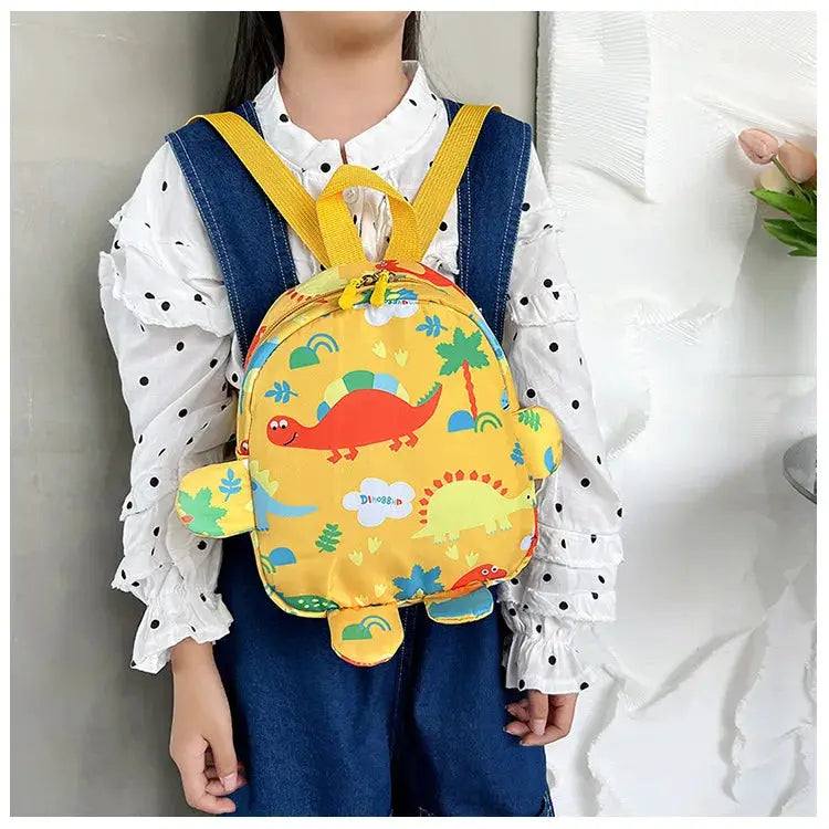 Kids dinosaur backpack in bright yellow with blue straps, cartoon dino print for school or travel