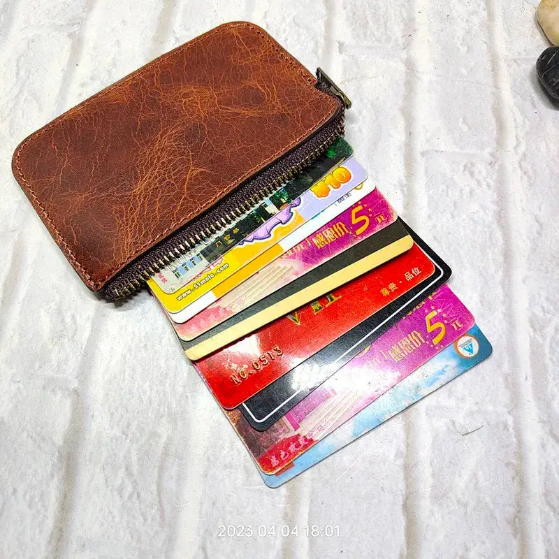 Brown leather mini zipper waist bag with multiple card slots and zip closure
