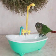 Parrot bath tub with yellow shower arm and blue connector, green plastic tub, bird perched on edge