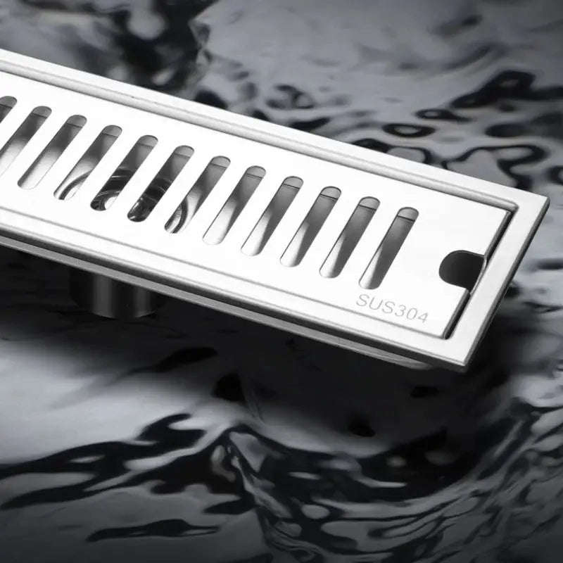 Long rectangular stainless steel bathroom floor drain with slotted grate, SUS304.