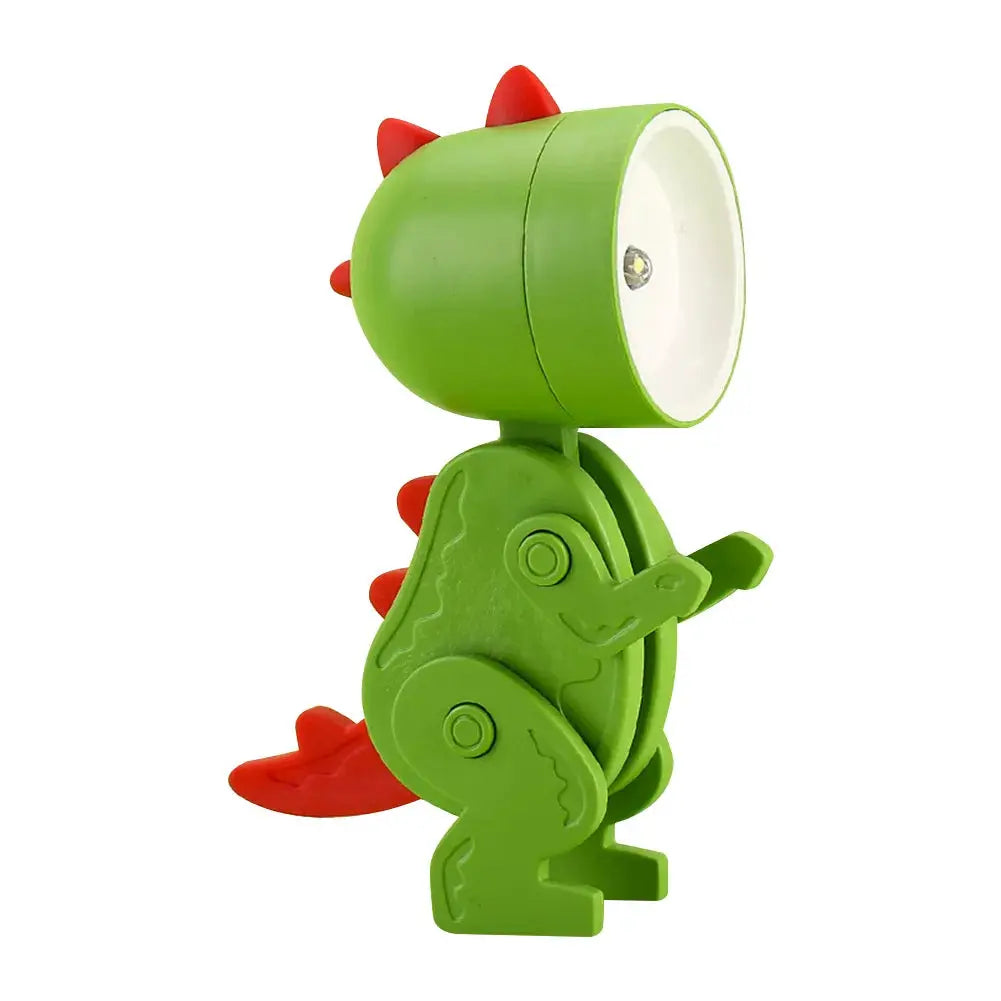Green dinosaur-shaped mini night light LED desk lamp with red spikes for kids’ bedside.