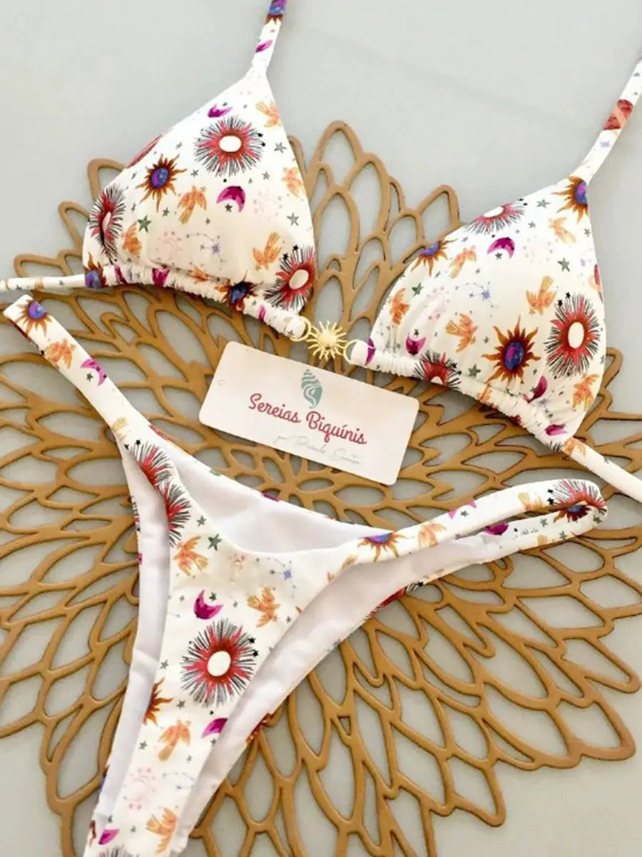 Micro bikini set in white with colorful sunburst print; halter top and thong bottom, Sereias Biquínis.