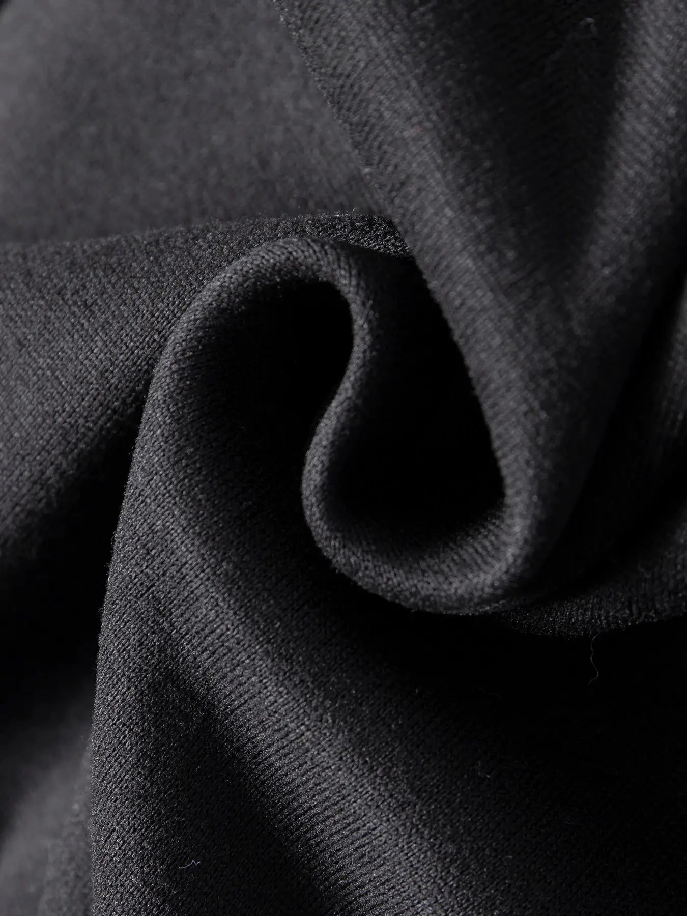 Men's black sweatpants fabric close-up showing knit texture
