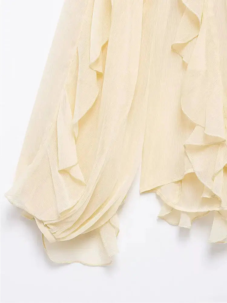 Women's cream chiffon blouse with cascading ruffles and long sleeves