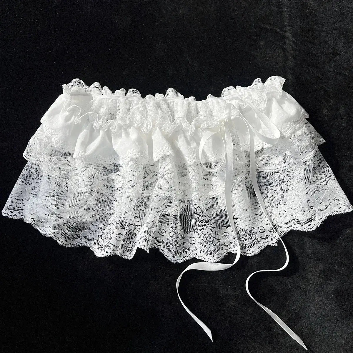 White lace layered mini skirt with ruffles and satin ribbon ties.
