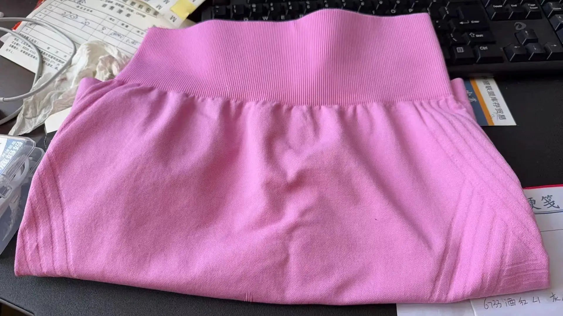 Pink high-waisted knitted yoga shorts with a ribbed waistband and stretchy fabric