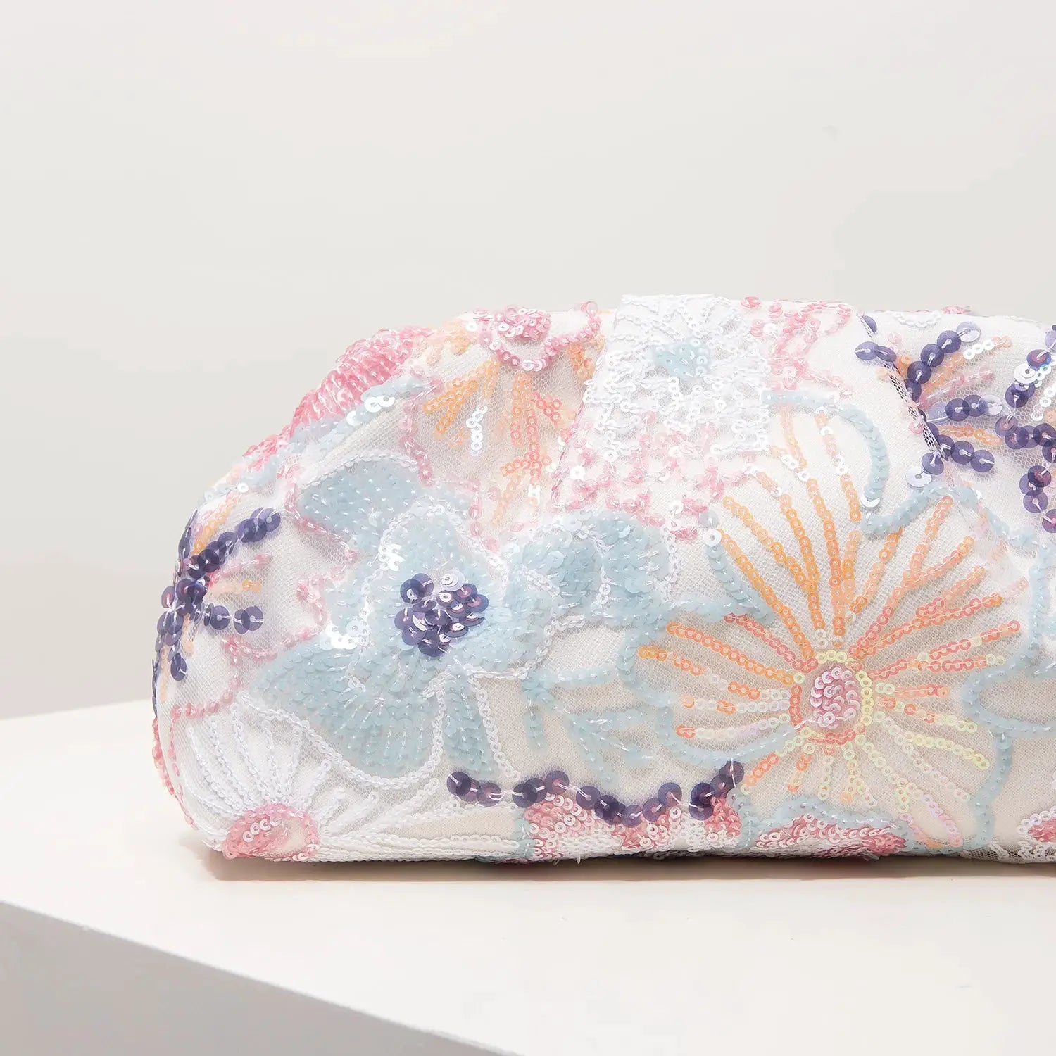 Clutch bag by Simples Market featuring pastel pink, blue and lavender sequin floral embroidery