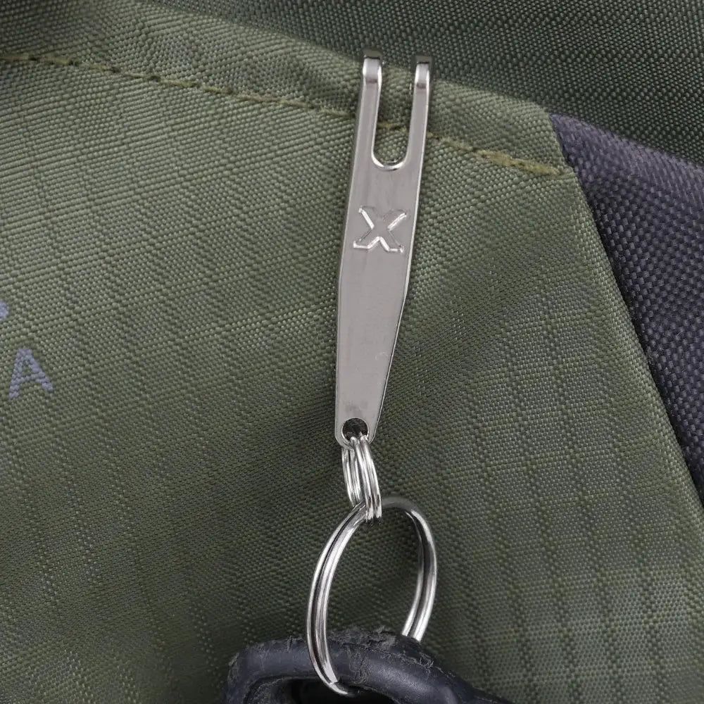 EDC pocket suspension clip with key carabiner, silver metal finish with X-mark on clip, on green bag fabric