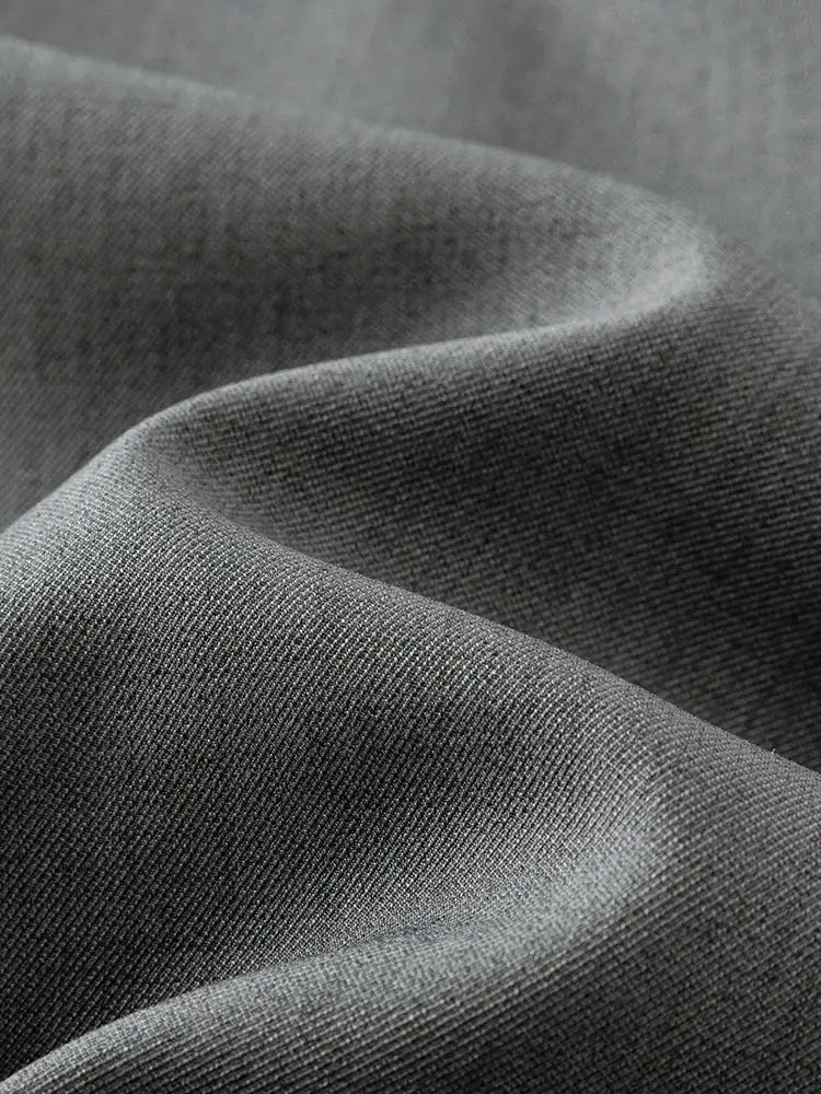 Skirt fabric close-up in grey; fine woven texture.