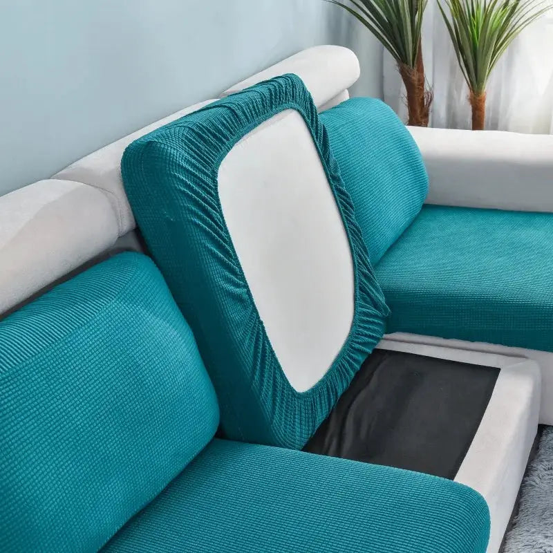 Polar fleece sofa cushion cover by Simples Market in teal with elastic edging on a sectional sofa.