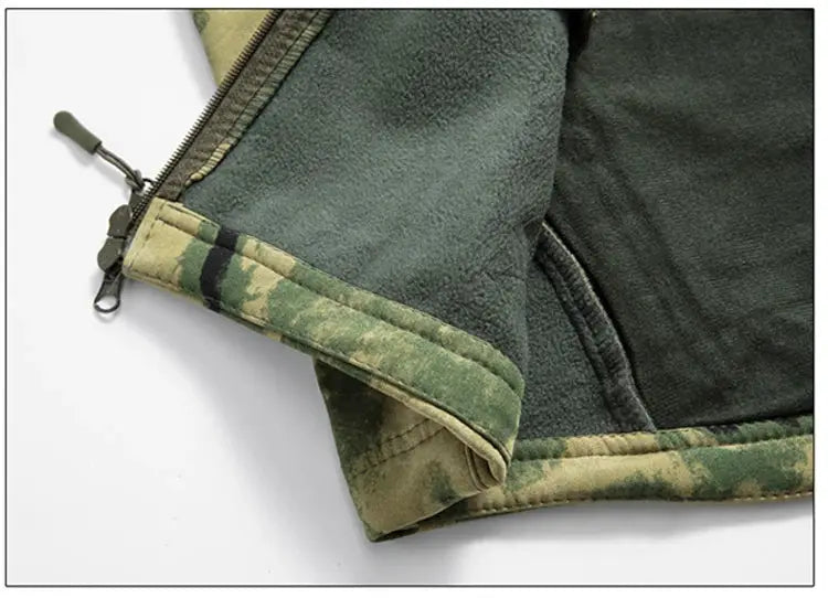 Lurker Shark Skin soft shell tactical jacket cuff in olive green with camouflage trim and fleece lining.