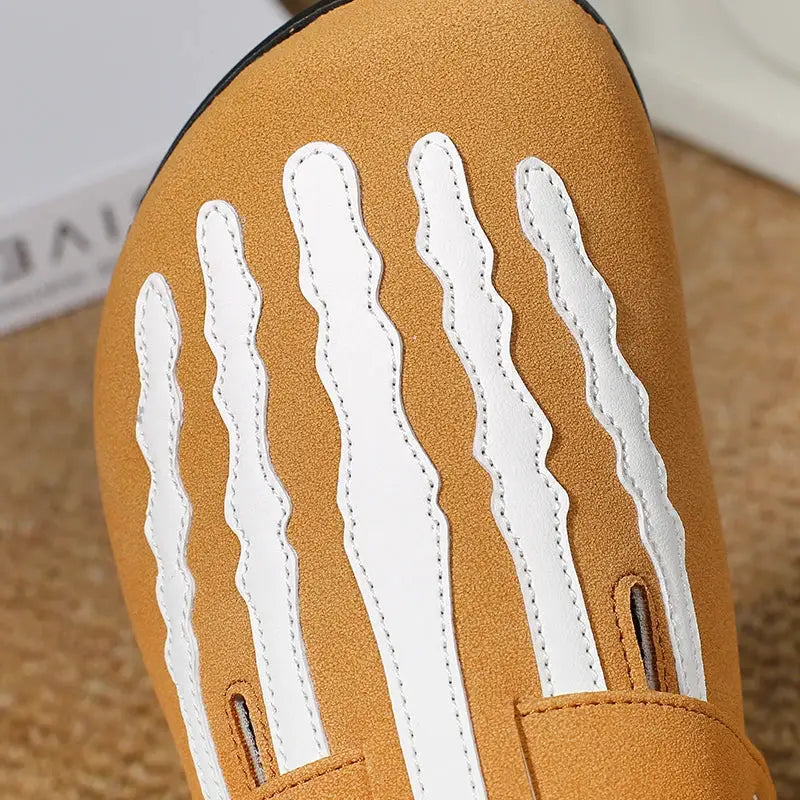 Cork clogs in tan with white stitched vertical panels on the upper