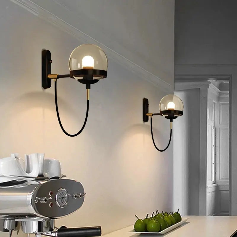 Modern glass ball wall lamp pair with clear globes, brass and black metal, Simples Market, E27.
