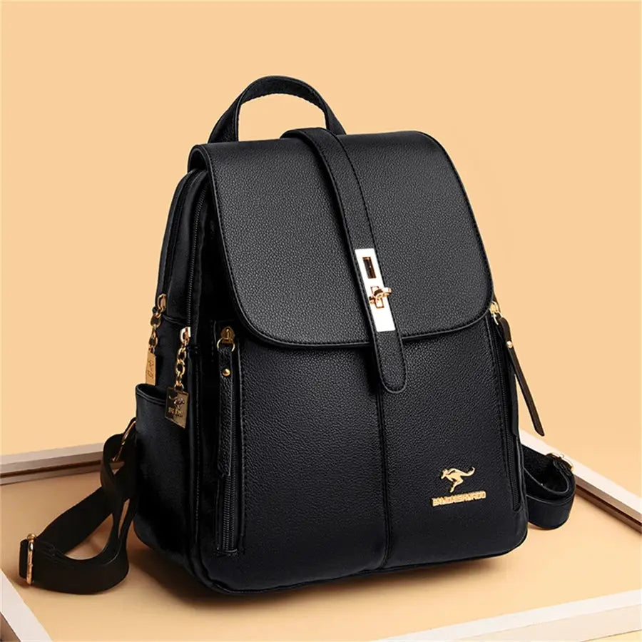 Leather backpack by Simples Market in black with gold hardware and front strap buckle.