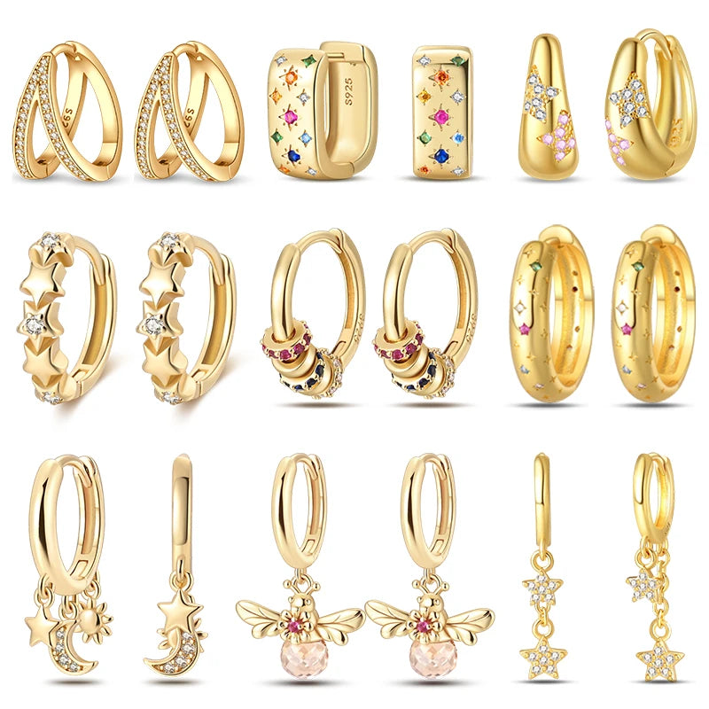 Gold-tone 15-piece earring set with hoops, huggies and charm studs featuring stars, moons, bees, pearls and crystals.