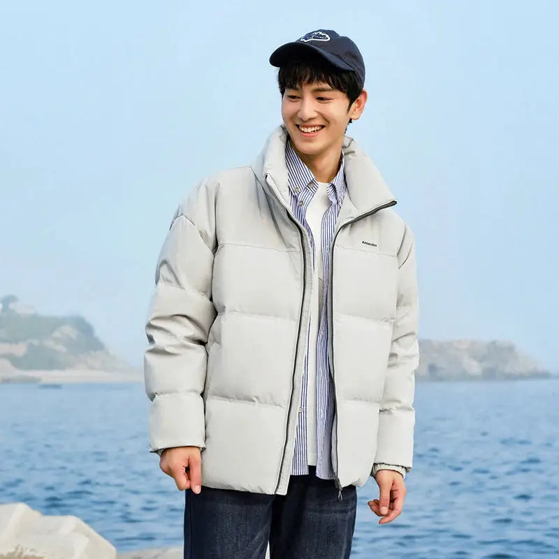 Semir down jacket; light gray, windproof waterproof puffer outerwear worn by a man by the sea