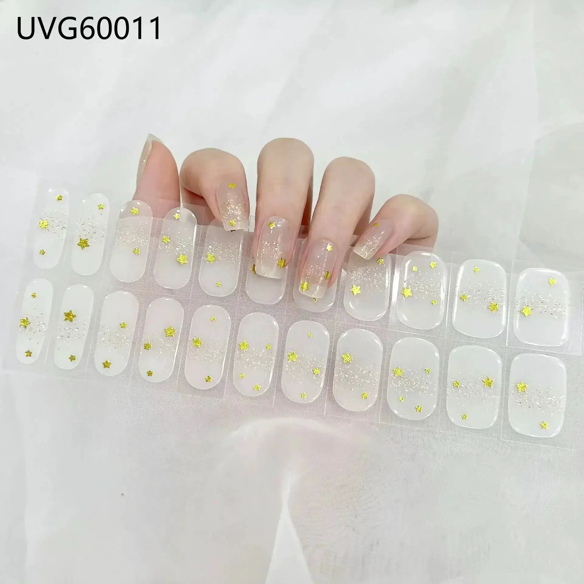 Gel nail wrap set with clear full-cover tips and gold star confetti accents
