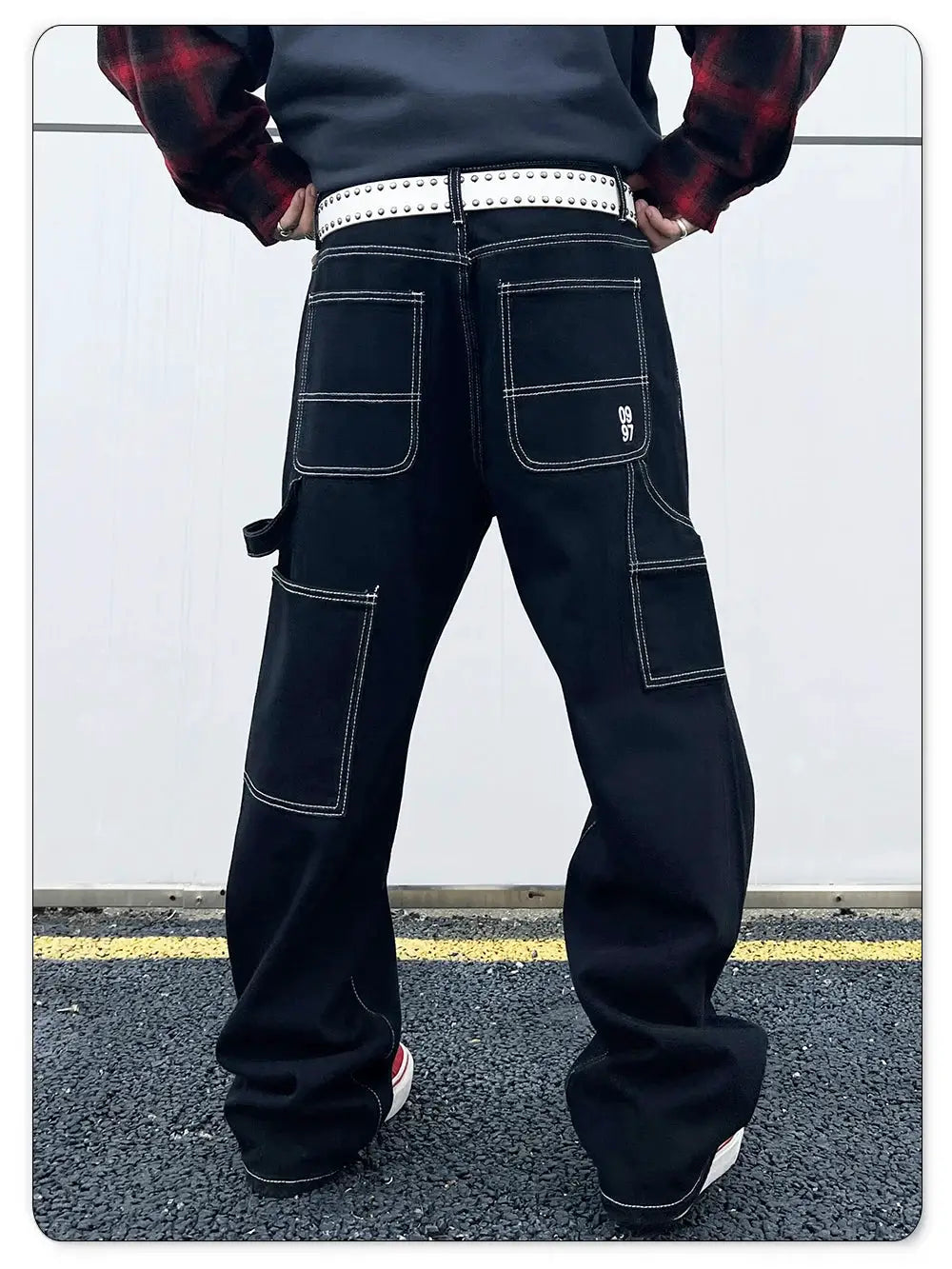 Men's black denim cargo jeans with white contrast stitching and multiple pockets