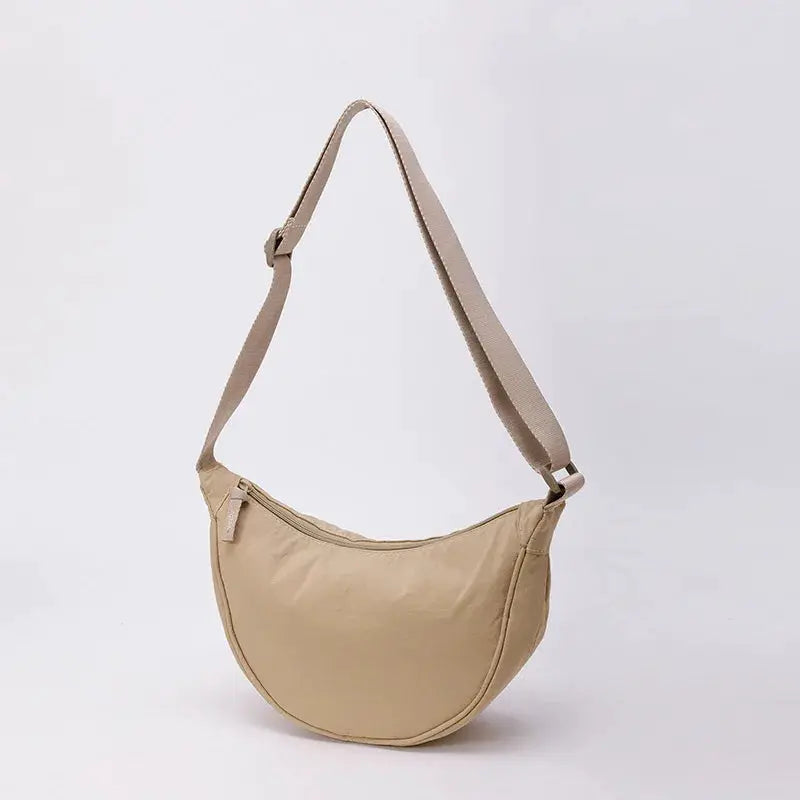 Nylon crossbody bag by Simples Market, crescent dumpling shape in beige with adjustable strap, large capacity.
