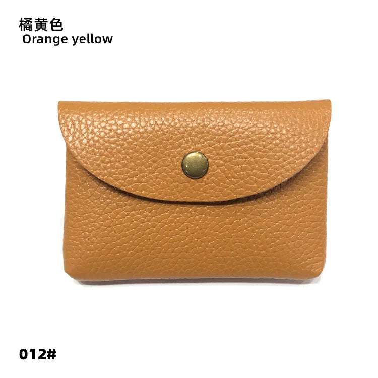 Card holder, orange-yellow genuine leather with curved flap and brass snap.