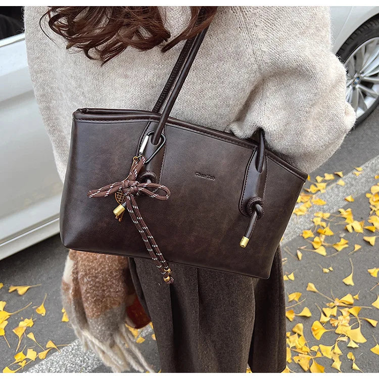 PU leather shoulder bag for women by Simples Market in dark brown with crossbody strap and bow charm