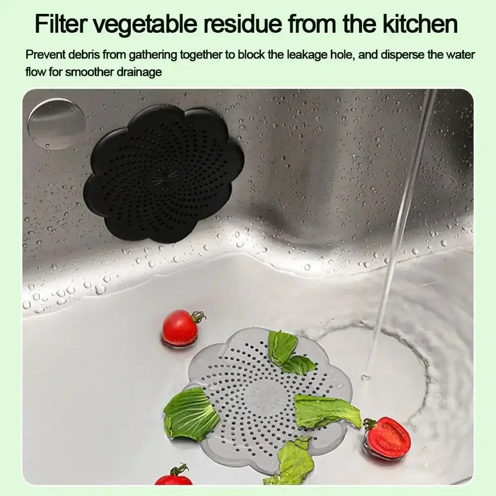 Two silicone flower-shaped sink drain covers in gray and black by Simples Market, anti-blocking hair catcher