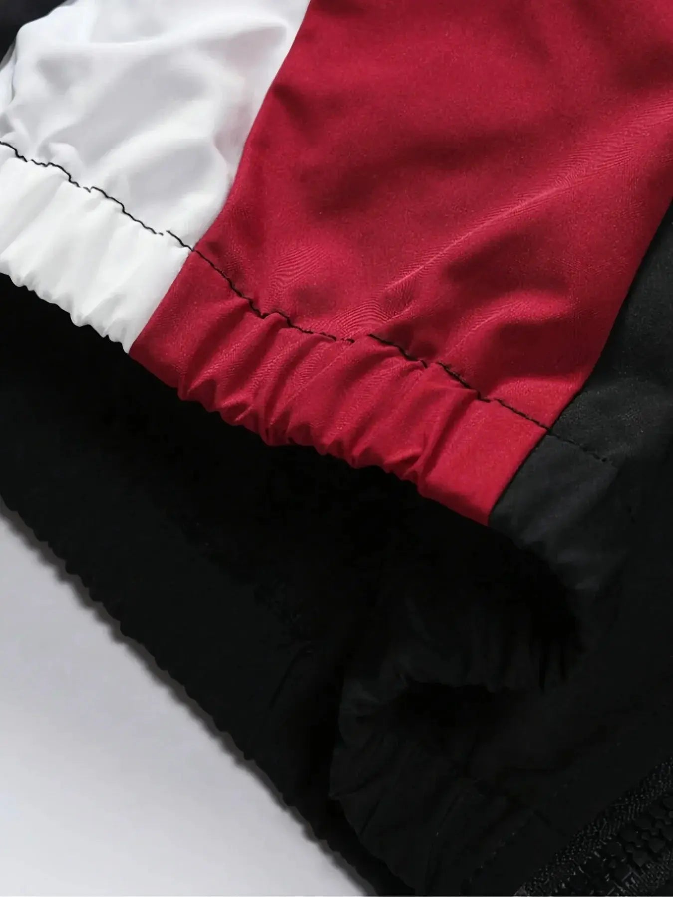 Men's color-blocked jacket with white, red and black panels and elastic cuffs