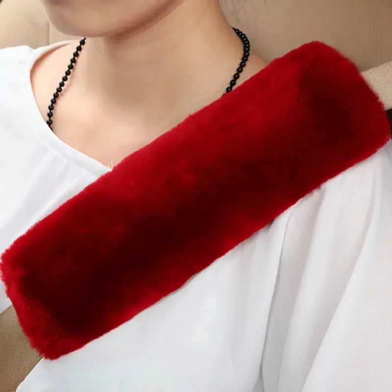 Car seat belt cover shoulder warmer pad, plush red fur worn across the shoulder