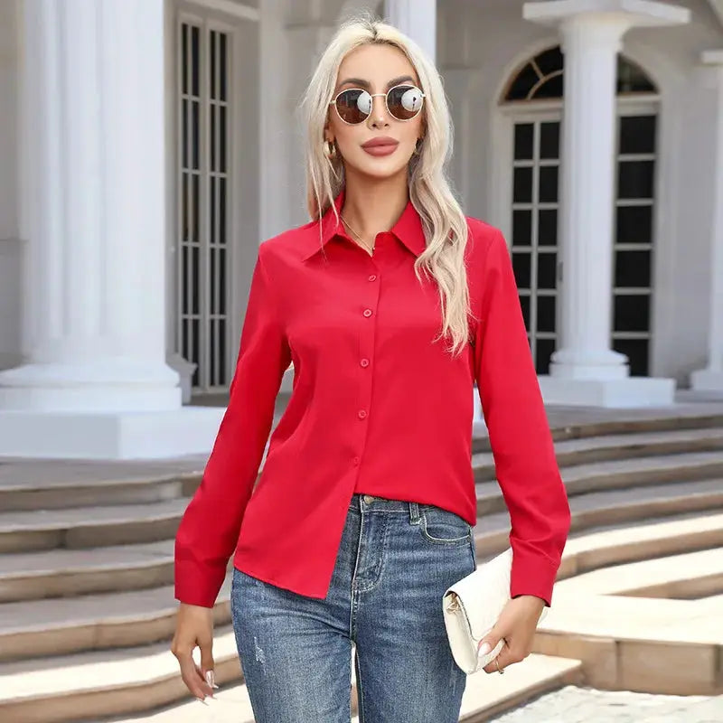 Women's red chiffon button-down shirt with long sleeves and turn-down collar, worn with jeans.
