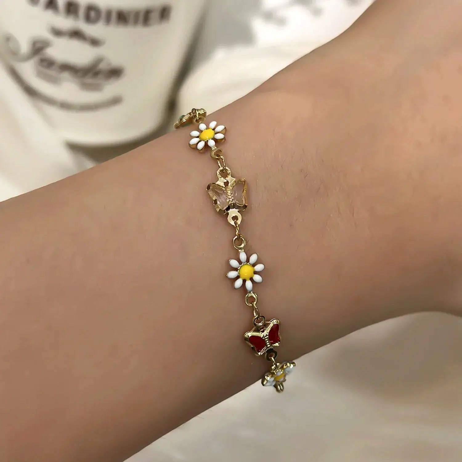 Sweet Daisy Flower bracelet on a gold-tone chain with white petals and yellow centers, daisy charms along the length