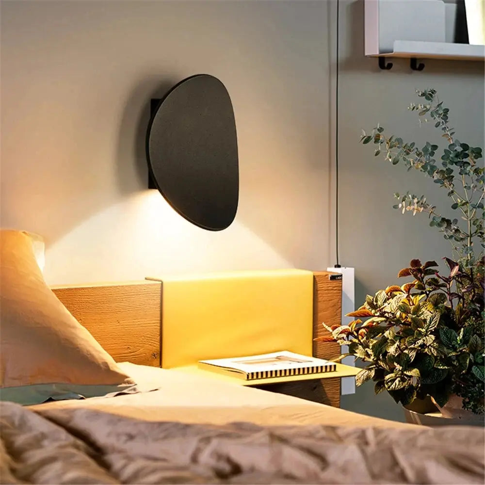 LED indoor wall lamp, black aluminum circular sconce above bed for modern bedroom lighting