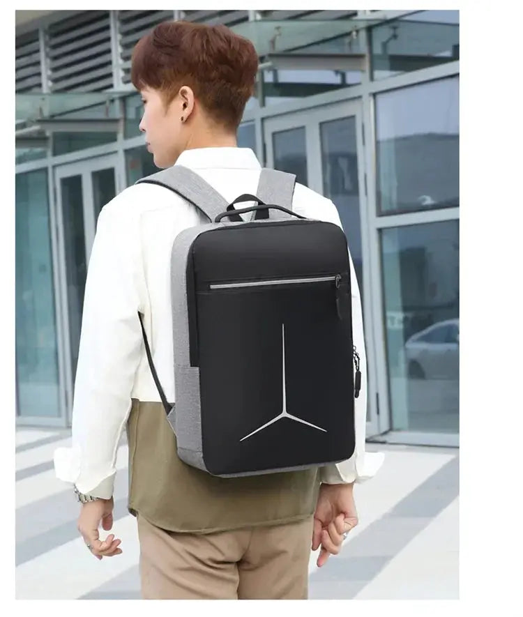 Anti-theft USB waterproof hard-shell laptop backpack, black with gray side panels.